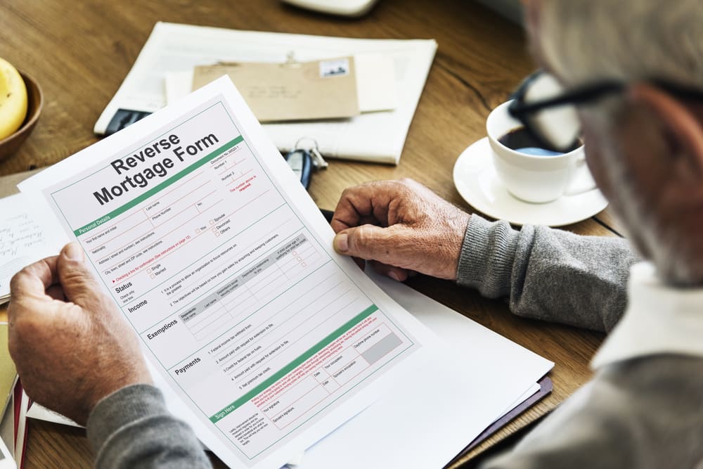 Man holding Reverse Mortgage Paper Form