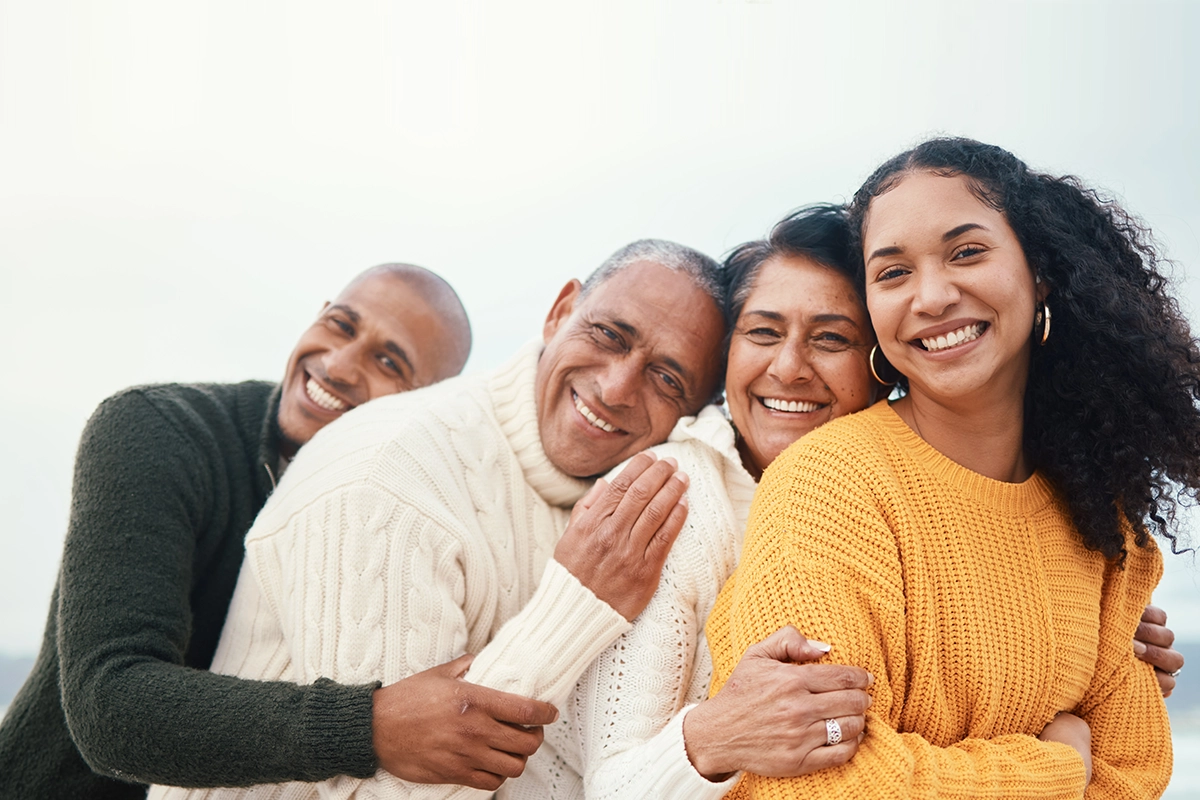 happy family and hug at the beach by siblings with mature parents on holiday